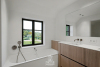 Tweede badkamer met ligbad, dubbele wastafel en douche