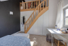 Vierde slaapkamer voorzien van praktisch vaste kastenwanden en een trap naar een hoger gelegen dressingruimte 