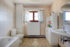 Badkamer met toilet, ligbad en wastafels